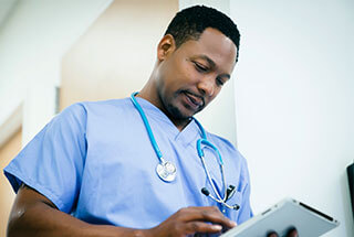 male nurse reading a chart