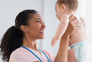 female nurse holding a baby