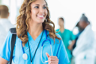female nurse in foreground with group of nurses behind